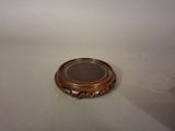 a small wooden plate sitting on a white surface