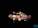 several different colored gems are arranged on a black surface