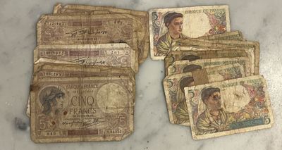 some old money sitting on top of a table next to each other