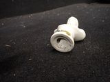 a small white object that is on a black surface