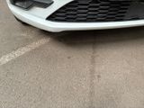 a picture of a white car parked in a parking lot