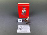 a small figurine of a man with a sword next to a red box