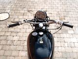 a close up of a motorcycle on a brick road