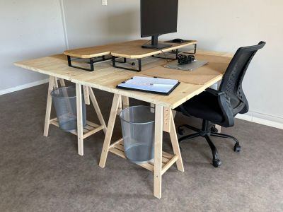 a desk with a computer and a chair in the room