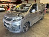the silver van is parked in a garage with other vehicles