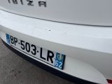 a close up of a white car with a number plate on it