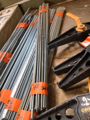many different types of steel rods and tools on the floor