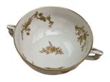 a white bowl with a gold decoration on it