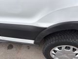 a close up of a white truck with a flat tire