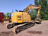 a large yellow excavator sitting in the dirt