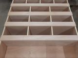 a wooden box that has a lot of compartments inside of it