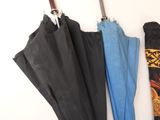 three umbrellas hanging on the wall next to each other