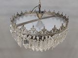 a glass chandelier hanging from a ceiling