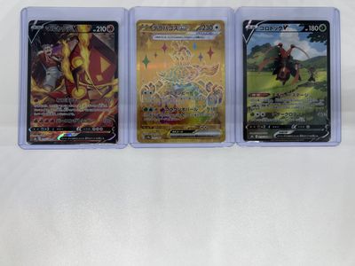 three different pokemon trading cards in plastic cases on a white surface