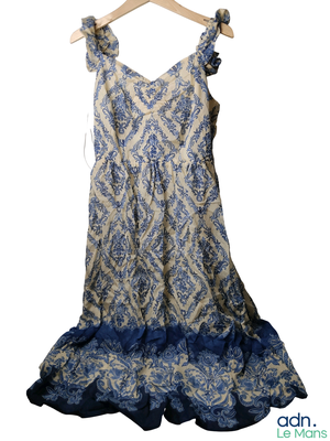 a blue and white dress hanging on a hanger
