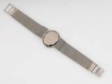 a close up of a wrist watch on a white surface