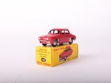 a red toy car sitting on top of a yellow box