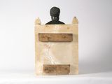 a sculpture of a man sitting on a chair