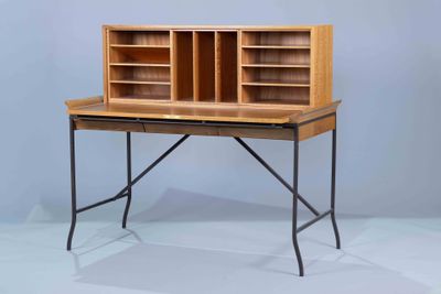 a wooden desk with a metal frame and a book shelf
