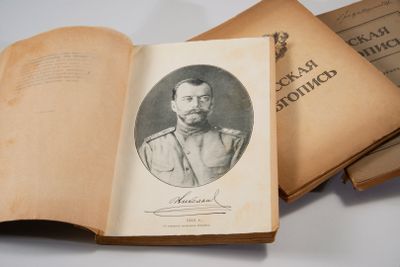 an old book with a picture of a man in a military uniform