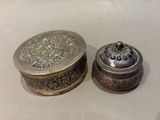 a silver box and a silver box sitting on a table