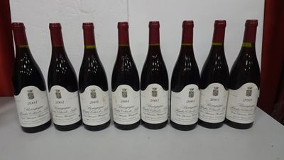 six bottles of wine are lined up on a table