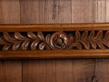 a wooden frame with a carved design on it