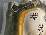 a figurine of a woman with chinese writing on it