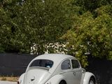 a small white car parked on the side of the road