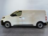 the white van is parked in a large room with a gray floor