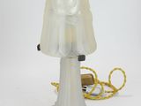 a lamp that is sitting on a table next to a cord