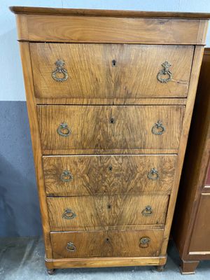 two wooden dressers and a chest of drawers in a room
