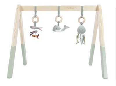 a wooden baby play set with toys hanging from it