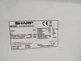 a close up of a sharp label on the side of a refrigerator