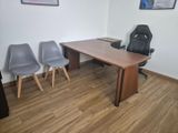 an image of a conference room with chairs and a desk