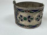 an antique silver and enamel bracelet with blue, green, and red flowers