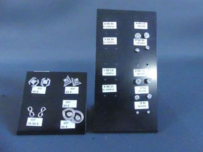 two black boards with stickers on them on a blue surface
