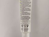 a close up of a tube of cream on a white surface