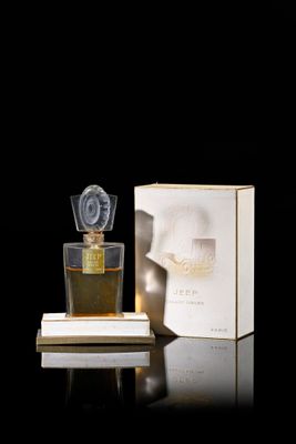 an image of a bottle of perfume sitting on a table next to a box