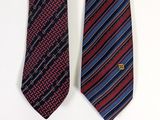 two ties are hanging on a wall next to each other