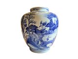 a blue and white vase sitting on a white surface