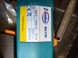 a close up of a blue box with a yellow tag on it