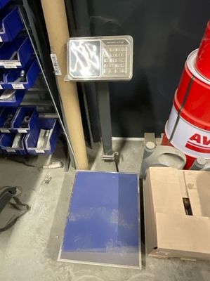 a red fire hydrant sitting next to a box of blue boxes