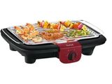 an image of a red and black grill with food on it