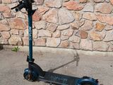a scooter that is parked in front of a stone wall