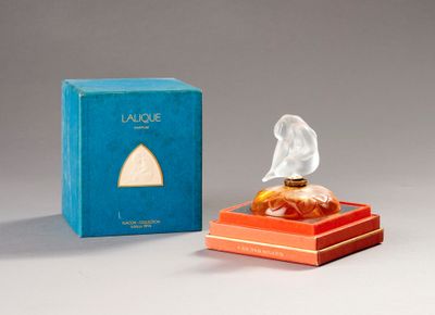 an image of a perfume bottle in a box next to a box of perfume