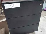 a black filing cabinet that is on the floor