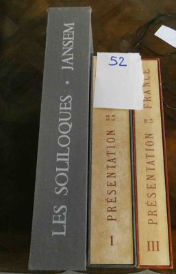 several books are stacked on top of each other on a table