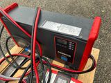 a red and black battery that is connected to a red and black charger