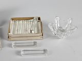 a box of cigarettes and a glass ashtray on a table